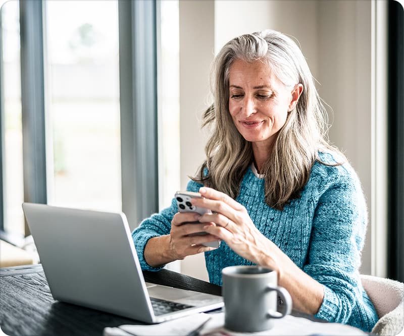 Woman Holding Phone with Coffee