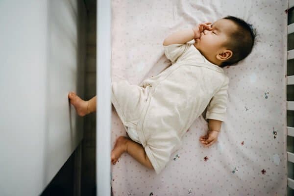 Baby sleeping in their crib.