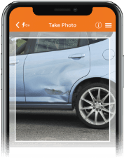 Smart phone with picture of vehicle damage displayed on the screen.