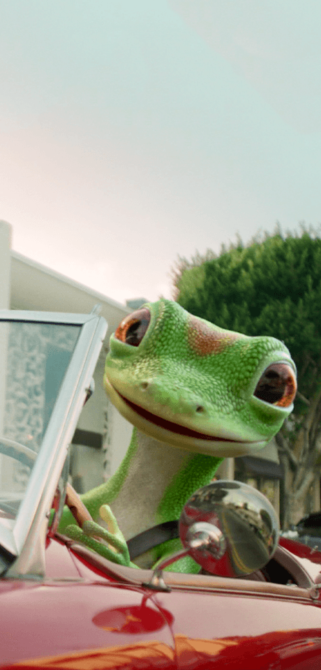 Gecko driving red convertible.