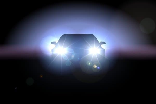 Car headlights at night.