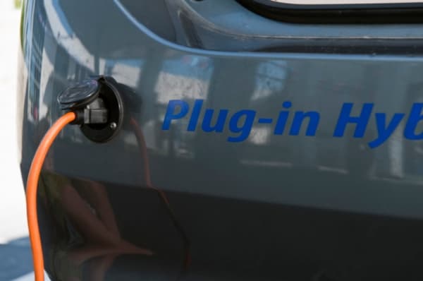 Hybrid vehicle plugged in to charge.