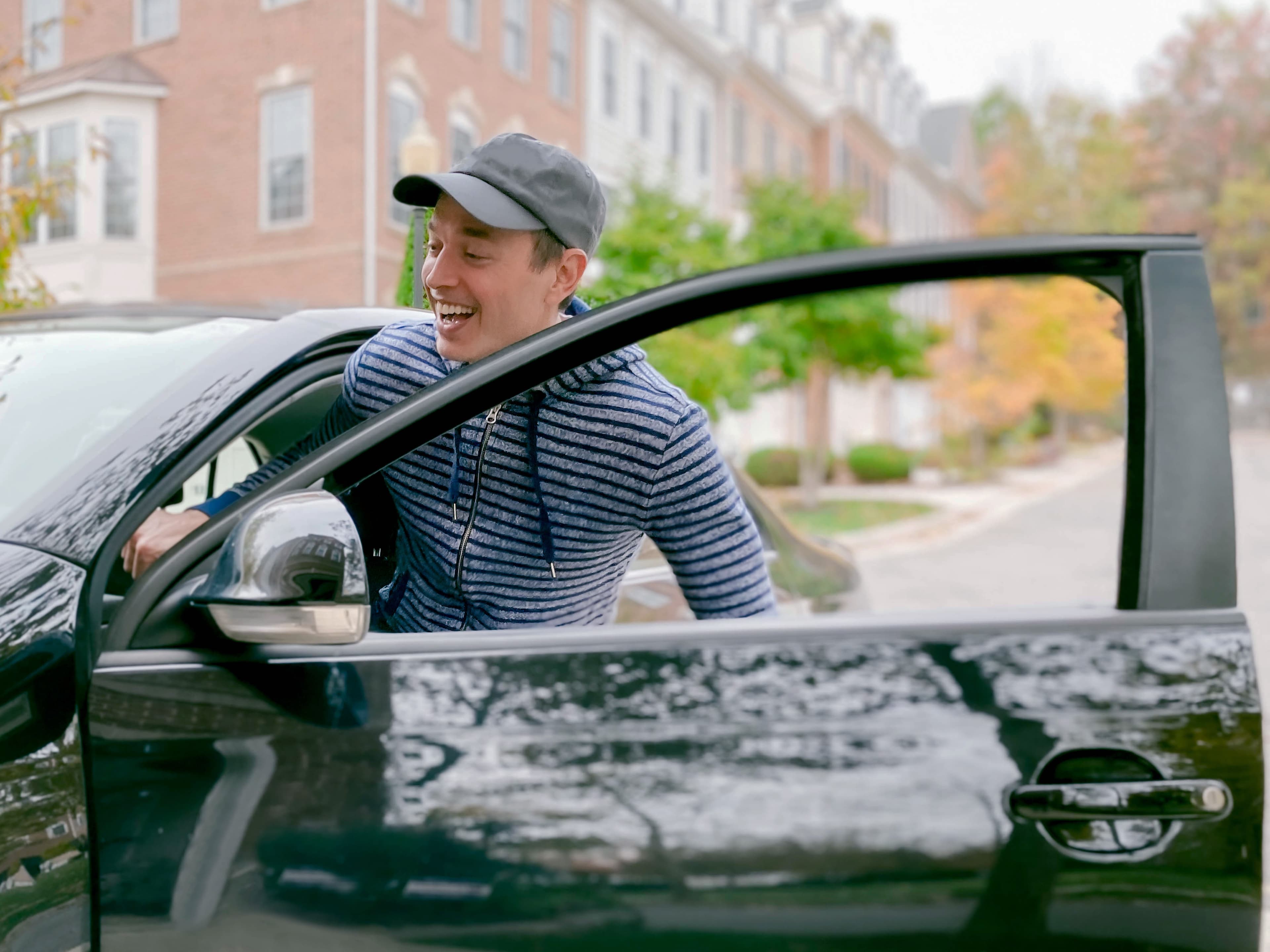 man getting into car