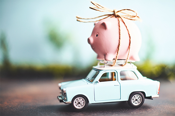 piggy bank strapped to roof of toy car