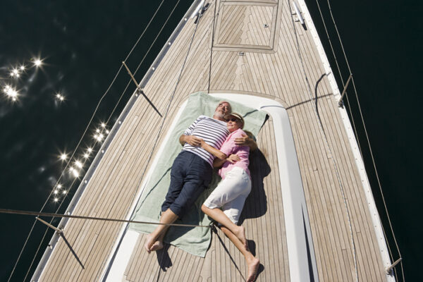 Couple asleep on deck of sailboat