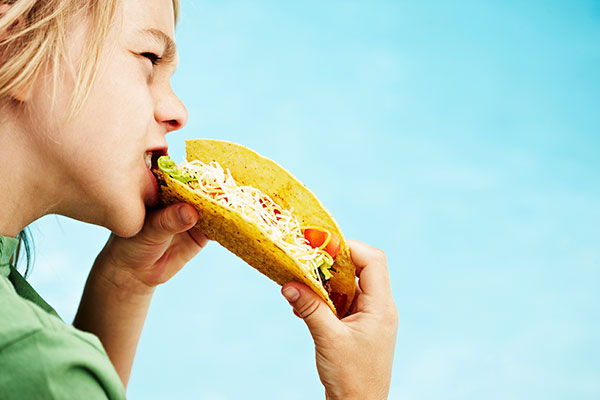 Boy eating taco