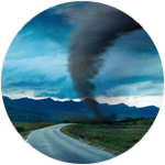 An empty road with a tornado in the distance