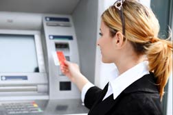 woman using bank ATM machine