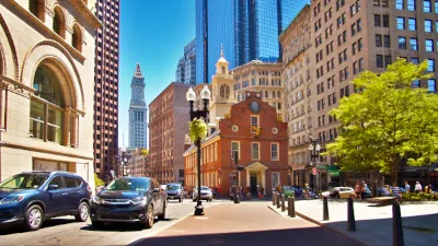 cars driving through downtown Boston near historic buildings, representing Boston car insurance needs.