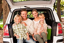 family sitting in the back of a mini-van