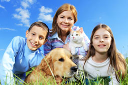 mother and kids with their pet dog and cat