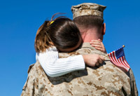 Military father hugging his daughter