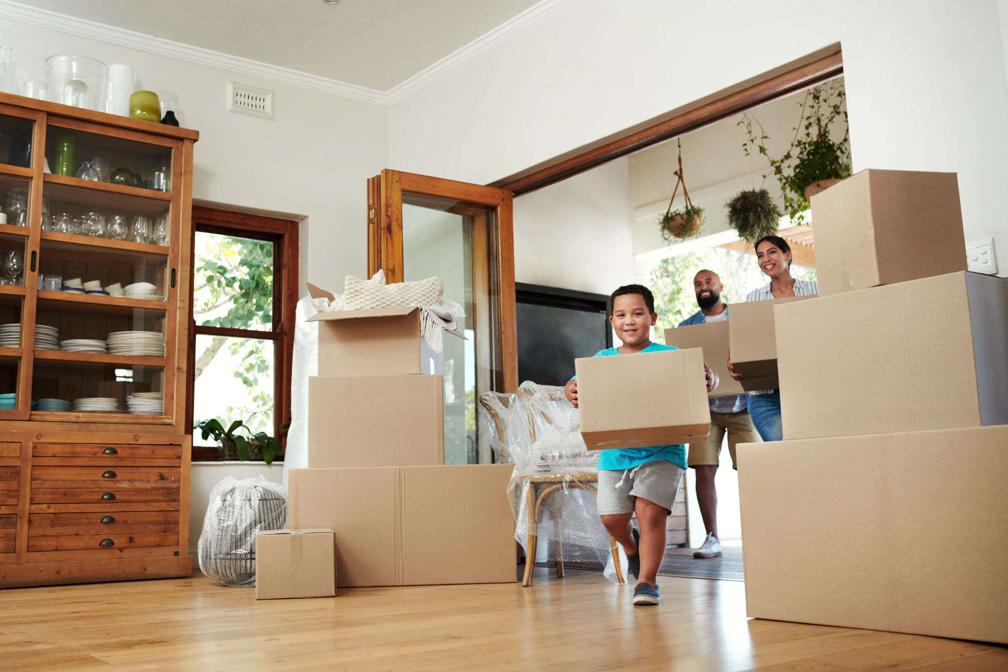 family moving into their new house, illustrating canceling renters insurance early when moving