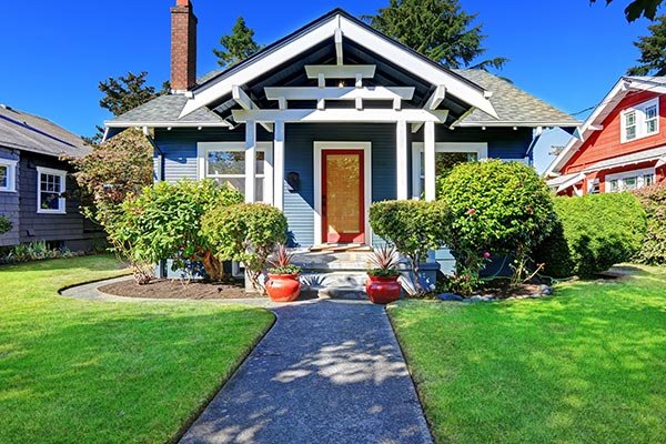 Image of a cute house taken from the street. The home has lots of decor around the front and looks welcoming. Great curb appeal.