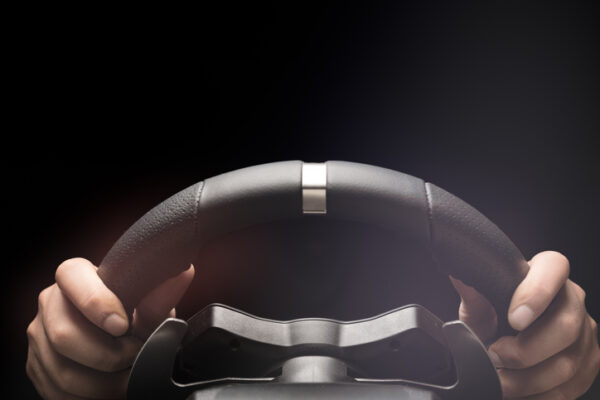 Hands on steering wheel of a car.