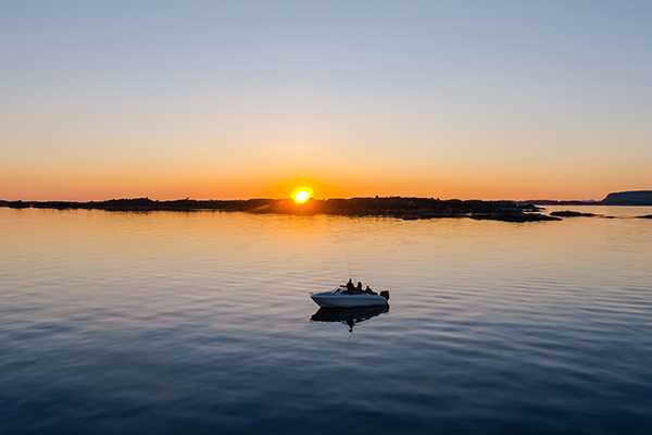 Fisherman out on a boat at sunset.