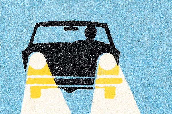 Illustration of a vehicle being driven at night with headlights on.