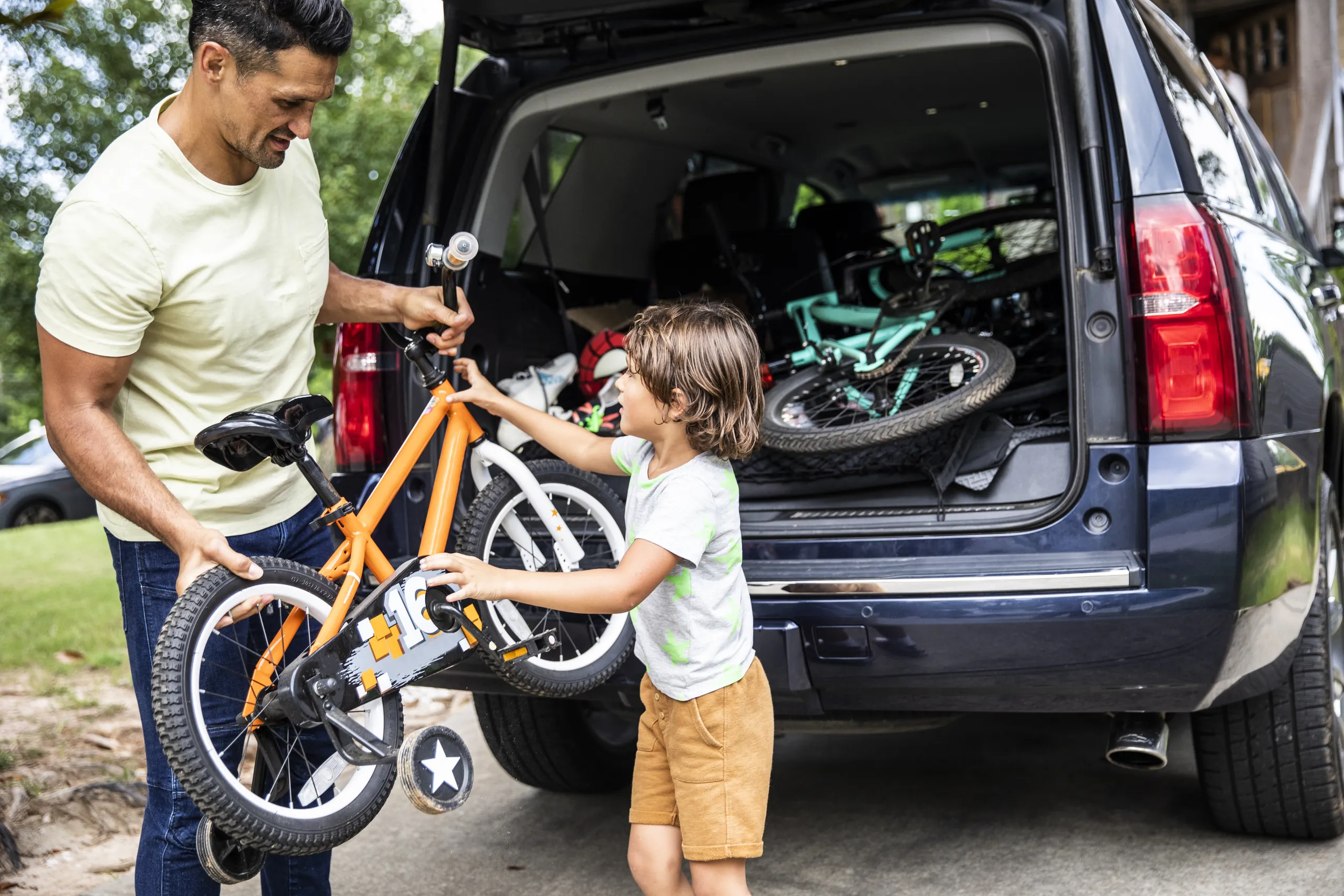 Person unloading bike from car.