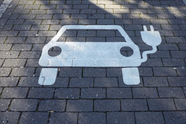 Parking spot reserved for electric and hybrid vehicles to charge.