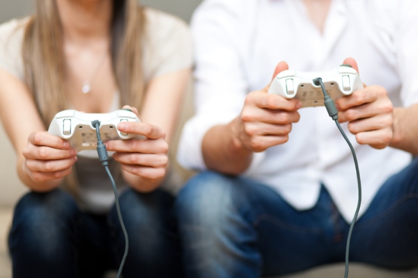 Close up of two people playing video games together.