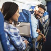 man and woman talking on airplane