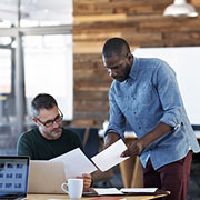 two men discussing paperwork