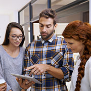group of people looking at a tablet