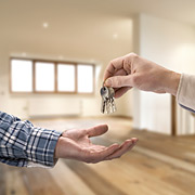 person giving set of keys to open hand
