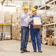 two men talking in warehouse