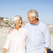 older couple walking on the beach