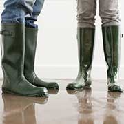 people wearing rubber boots standing in water