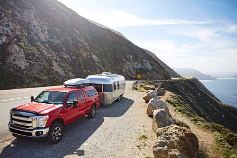 A travel trailer parked on the side of the road. Used to show the importance of travel trailer insurance.